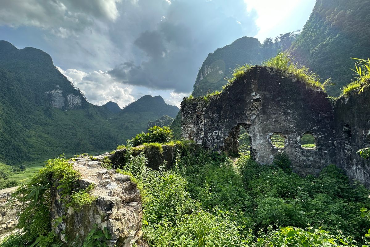 Lung Ho Wall Relic in Ha Giang, Vietnam, showing ancient stone structures along a mountain slope.